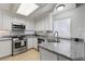 Updated kitchen featuring stainless steel appliances, granite counters and natural lighting at 10273 Grecian Laurel Ct, Las Vegas, NV 89183