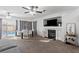 Bright living room with fireplace, ceiling fans and dining area with sliding door to the backyard pool at 10273 Grecian Laurel Ct, Las Vegas, NV 89183