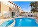 Backyard pool area featuring a uniquely shaped pool and outdoor furniture at 10273 Grecian Laurel Ct, Las Vegas, NV 89183