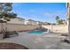 Private backyard with a custom pool, rock waterfall, and lounge area at 10273 Grecian Laurel Ct, Las Vegas, NV 89183