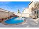 Backyard features a custom pool with rock waterfall, spa, and a patio at 10273 Grecian Laurel Ct, Las Vegas, NV 89183