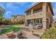 Well-maintained backyard featuring an artificial lawn, stone landscaping, and patio seating at 10313 Aragon Crown Rd, Las Vegas, NV 89135