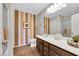 Bright bathroom featuring a dual sink vanity and a shower with glass door at 10313 Aragon Crown Rd, Las Vegas, NV 89135