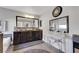 Bathroom with dark wood cabinets, large mirrors, and a separate vanity at 10313 Aragon Crown Rd, Las Vegas, NV 89135