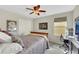 Comfortable bedroom features neutral tones, a ceiling fan, and space for a desk at 10313 Aragon Crown Rd, Las Vegas, NV 89135