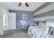 Serene bedroom showcasing stripe accent wall, soft textures, and a cozy atmosphere at 10313 Aragon Crown Rd, Las Vegas, NV 89135