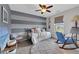 Cozy bedroom with a daybed, striped accent wall, and plush rug at 10313 Aragon Crown Rd, Las Vegas, NV 89135