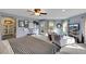 Spacious bedroom showcasing ceiling fan, balcony, and ensuite sitting area at 10313 Aragon Crown Rd, Las Vegas, NV 89135