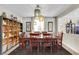 Dining room with dark wood table, black chairs, open shelving, and elegant lighting at 10313 Aragon Crown Rd, Las Vegas, NV 89135