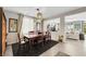 Formal dining room featuring a dark wood table, matching chairs, and stylish lighting fixtures at 10313 Aragon Crown Rd, Las Vegas, NV 89135