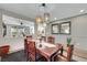 Traditional dining room with wooden table, pendant lighting, and view into another room at 10313 Aragon Crown Rd, Las Vegas, NV 89135