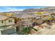 A picturesque two-story home featuring a well-manicured lawn, mature trees, and a paved driveway at 10313 Aragon Crown Rd, Las Vegas, NV 89135