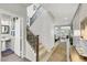 Bright foyer with staircase, entry to half bath, and access to the living room at 10313 Aragon Crown Rd, Las Vegas, NV 89135