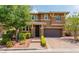 Charming two-story home featuring a landscaped yard, brick accents, and a welcoming entryway at 10313 Aragon Crown Rd, Las Vegas, NV 89135