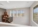Hallway with view of staircase, bookshelf, and bright windows at 10313 Aragon Crown Rd, Las Vegas, NV 89135