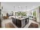 Open-concept kitchen with granite counters, large island, and seamless flow to the living area at 10313 Aragon Crown Rd, Las Vegas, NV 89135