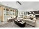 Inviting living room showcasing open floor plan, comfortable seating, and ample natural light from large windows at 10313 Aragon Crown Rd, Las Vegas, NV 89135