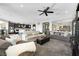 Spacious living room featuring plush seating, ceiling fan, and open concept to kitchen for modern living at 10313 Aragon Crown Rd, Las Vegas, NV 89135