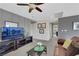 Cozy upstairs living area with a large TV, ceiling fan, and comfortable seating at 10313 Aragon Crown Rd, Las Vegas, NV 89135