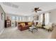 Upstairs living room features a ceiling fan, large windows, and comfortable seating at 10313 Aragon Crown Rd, Las Vegas, NV 89135