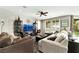 Bright living room featuring cozy seating, TV, and large windows allowing natural light to fill the space at 10313 Aragon Crown Rd, Las Vegas, NV 89135