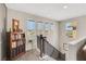 Bright staircase landing area with a bookcase, window, and view of the neighborhood at 10313 Aragon Crown Rd, Las Vegas, NV 89135