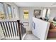 Carpeted staircase with dark wood railing, leading to a cozy living area at 10313 Aragon Crown Rd, Las Vegas, NV 89135