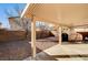 Spacious backyard with covered patio, gravel landscape, and brick walls at 11147 Verismo St, Las Vegas, NV 89141