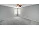 Bedroom with carpeted floor, ceiling fan, and two windows at 11147 Verismo St, Las Vegas, NV 89141