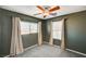 Well-lit bedroom features neutral curtains and a modern ceiling fan at 11147 Verismo St, Las Vegas, NV 89141