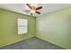 Cozy bedroom featuring a ceiling fan, window, and soft green walls at 11147 Verismo St, Las Vegas, NV 89141