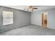 Comfortable carpeted bedroom featuring a ceiling fan and natural light at 11147 Verismo St, Las Vegas, NV 89141