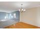 Open floor plan with hardwood dining area and carpeted living room with plenty of natural light at 11147 Verismo St, Las Vegas, NV 89141