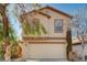 Two-story stucco home with a two-car garage and low maintenance desert landscaping at 11147 Verismo St, Las Vegas, NV 89141