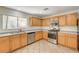 The modern kitchen has stainless steel appliances, light-colored wood cabinets, and tile flooring for a clean, updated look at 11147 Verismo St, Las Vegas, NV 89141