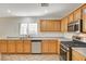 Well-lit kitchen features stainless appliances, tile flooring, and light wood cabinets for a classic and functional space at 11147 Verismo St, Las Vegas, NV 89141