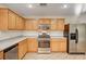 Modern kitchen with stainless steel appliances, light wood cabinetry, and neutral countertops at 11147 Verismo St, Las Vegas, NV 89141