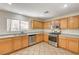 This functional kitchen features modern stainless steel appliances, light wood cabinets, and ample counter space at 11147 Verismo St, Las Vegas, NV 89141