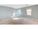 Expansive living room with carpet flooring, bright windows, and neutral paint at 11147 Verismo St, Las Vegas, NV 89141