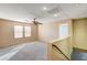 Spacious living room featuring plush carpet, ceiling fan, and bright natural light at 11147 Verismo St, Las Vegas, NV 89141