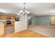 The open-concept living room features hardwood floors, plenty of natural light, and is adjacent to the kitchen and dining area at 11147 Verismo St, Las Vegas, NV 89141