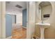 Charming powder room with pedestal sink and decorative round mirror at 11147 Verismo St, Las Vegas, NV 89141