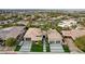 Gorgeous aerial view of home with lush landscaping, palms, modern drive, and neutral-toned tile roof at 1704 Tangiers Dr, Henderson, NV 89012