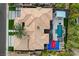 Birds eye view of home with pool, hot tub, basketball court, palm trees and modern tile roof at 1704 Tangiers Dr, Henderson, NV 89012