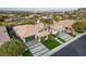Stunning aerial view of the home with lush landscaping, multiple garages, and a circular driveway at 1704 Tangiers Dr, Henderson, NV 89012