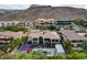 Unique aerial view of the home with pool, basketball court, mountain views and patios at 1704 Tangiers Dr, Henderson, NV 89012