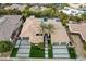 Panoramic aerial of the house showcasing dual garages, palm trees, modern hardscape and unique layout at 1704 Tangiers Dr, Henderson, NV 89012