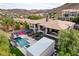 Stunning aerial view of the property featuring a pool, basketball court, spa and lush greenery at 1704 Tangiers Dr, Henderson, NV 89012