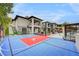 Sprawling backyard featuring a basketball court, trampoline, and a view of the modern home's architecture at 1704 Tangiers Dr, Henderson, NV 89012