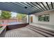 Spacious wooden deck with pergola, offering shade and relaxation in the backyard area at 1704 Tangiers Dr, Henderson, NV 89012